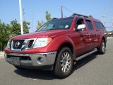 2009 Red Brick Nissan Frontier LE Crew Cab 4x4 #85592724
