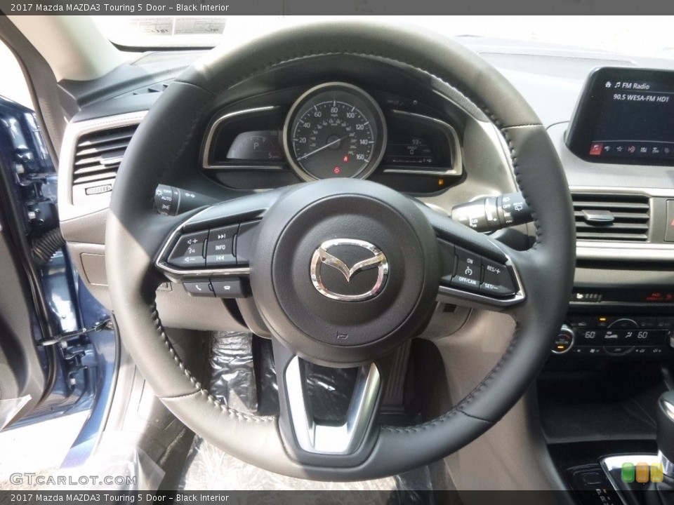 Black Interior Steering Wheel for the 2017 Mazda MAZDA3 Touring 5 Door #121044725