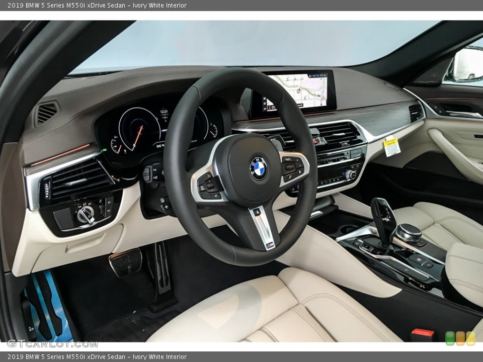 Ivory White Interior Dashboard for the 2019 BMW 5 Series M550i xDrive Sedan #131508397