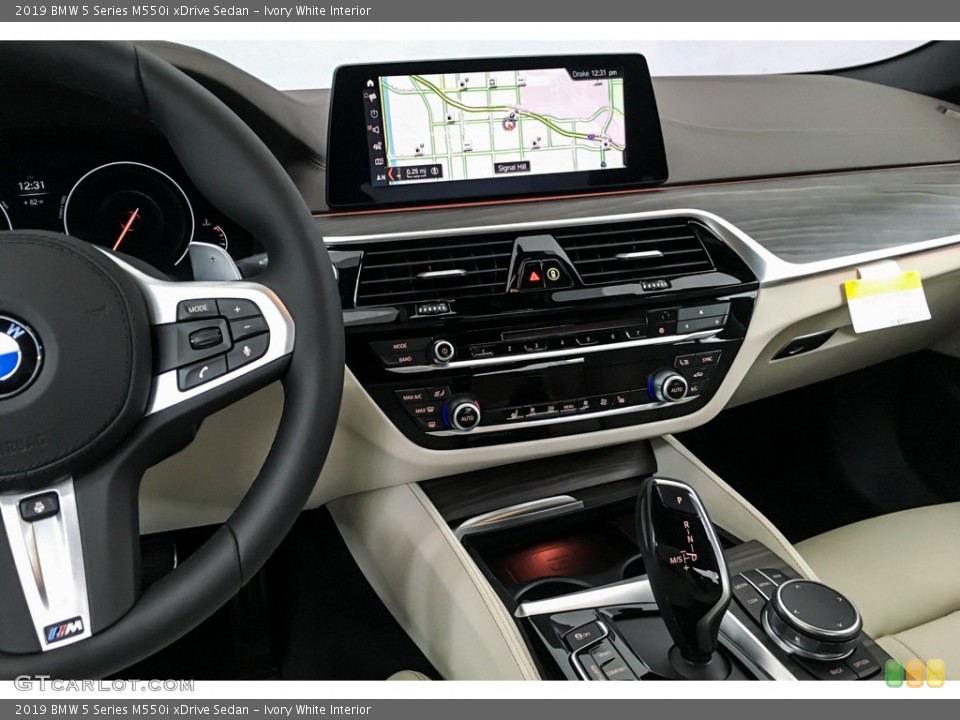 Ivory White Interior Dashboard for the 2019 BMW 5 Series M550i xDrive Sedan #131508421