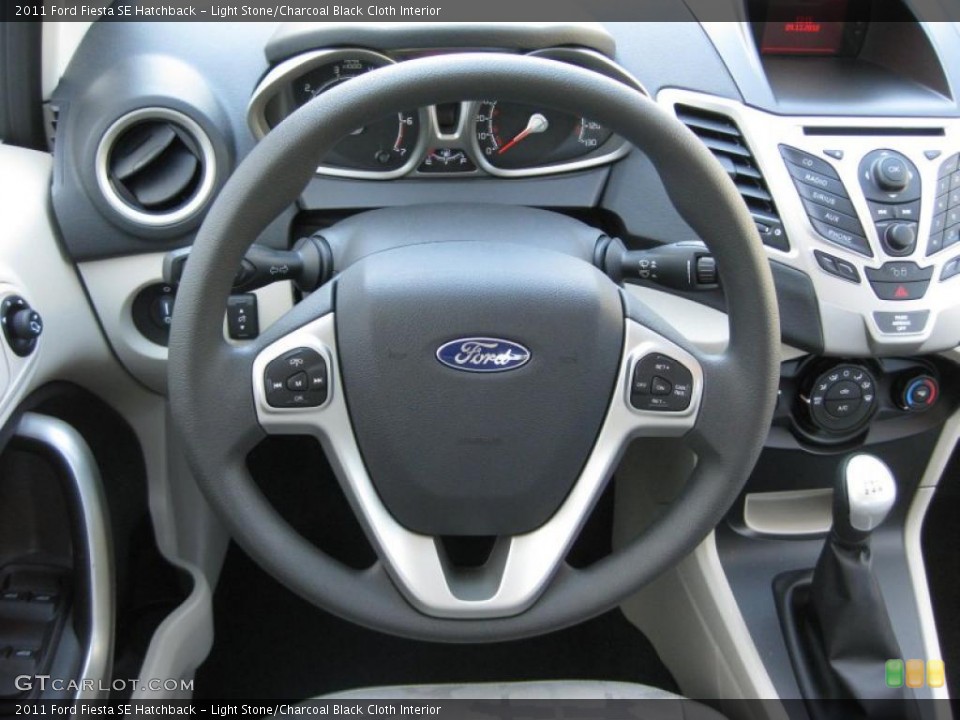 Light Stone/Charcoal Black Cloth Interior Steering Wheel for the 2011 Ford Fiesta SE Hatchback #37889652