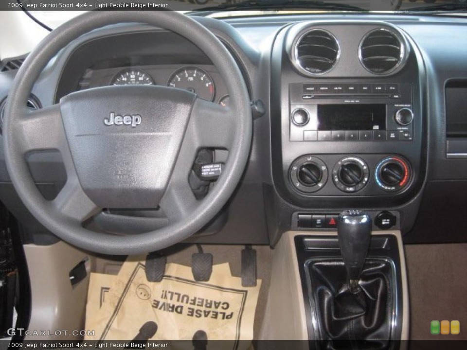 Light Pebble Beige Interior Dashboard for the 2009 Jeep Patriot Sport 4x4 #38429745
