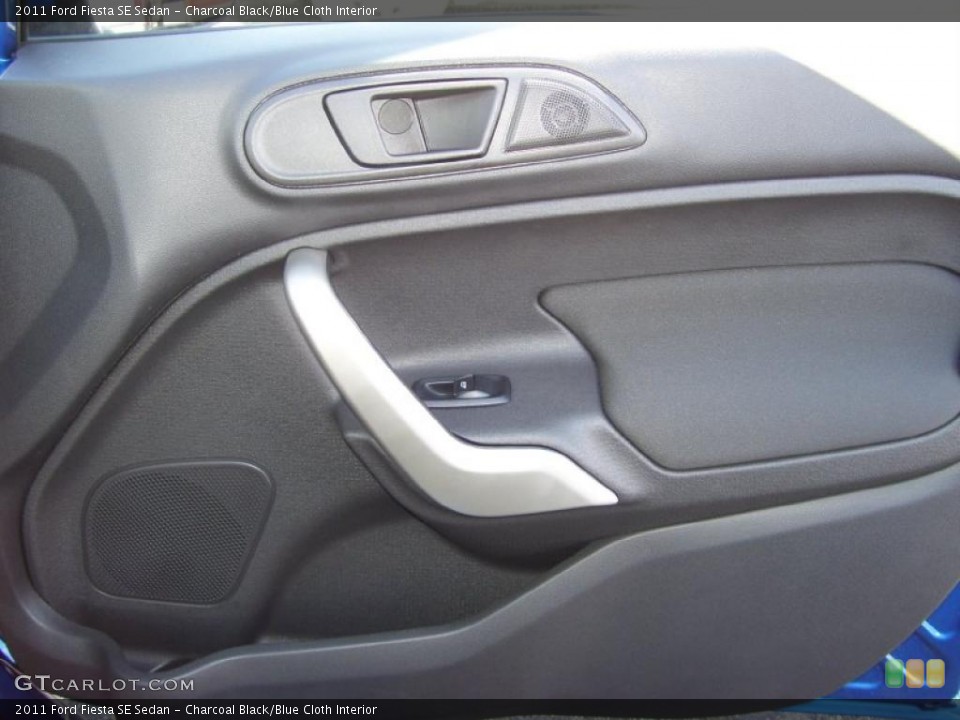 Charcoal Black/Blue Cloth Interior Door Panel for the 2011 Ford Fiesta SE Sedan #39127351