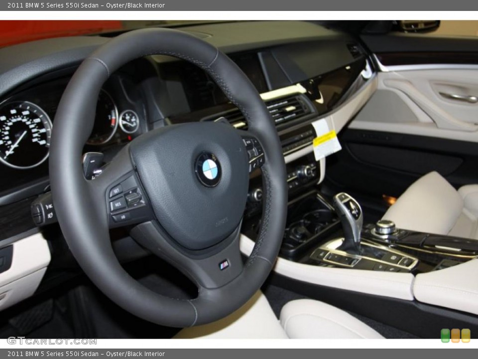 Oyster/Black Interior Steering Wheel for the 2011 BMW 5 Series 550i Sedan #42634532