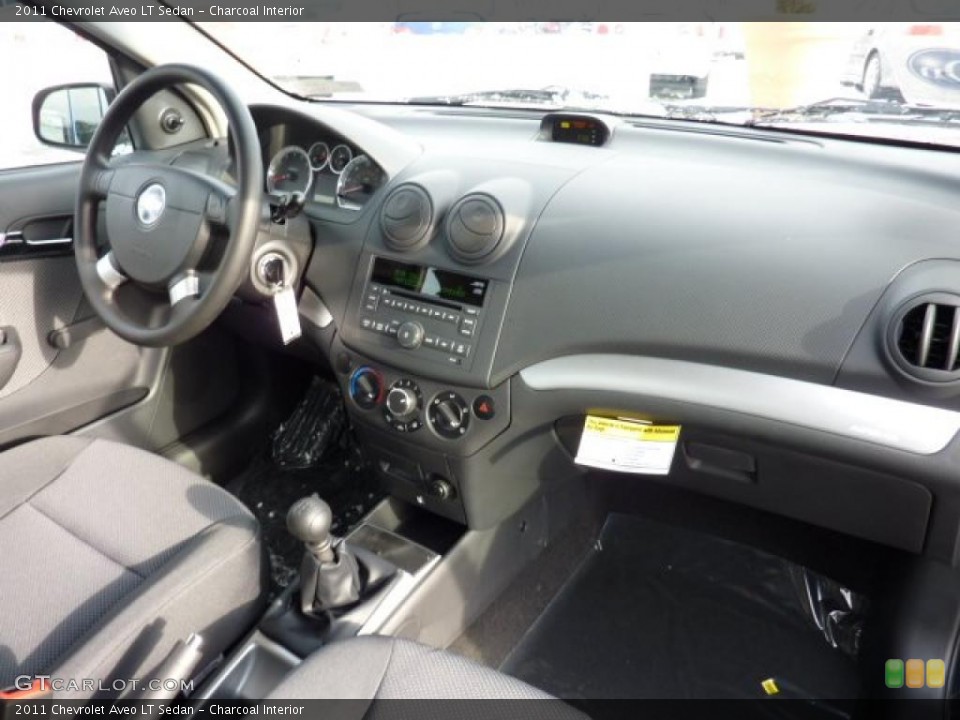 Charcoal Interior Dashboard for the 2011 Chevrolet Aveo LT Sedan #42720485