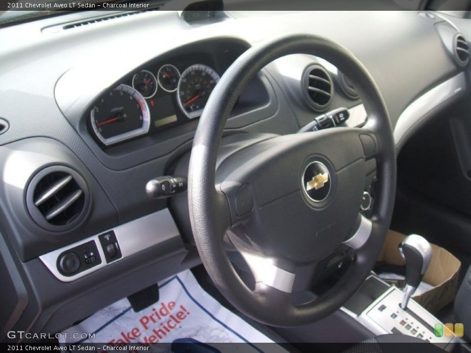 Charcoal Interior Steering Wheel for the 2011 Chevrolet Aveo LT Sedan #46103687