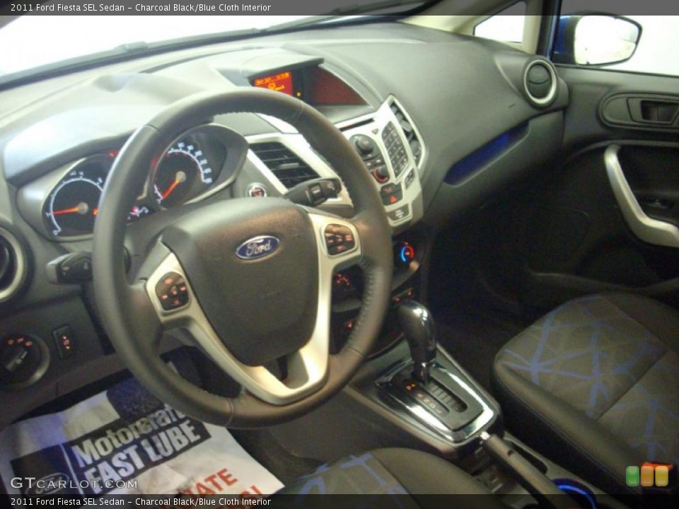 Charcoal Black/Blue Cloth Interior Prime Interior for the 2011 Ford Fiesta SEL Sedan #46385850