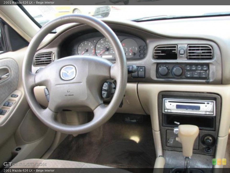 Beige Interior Dashboard for the 2001 Mazda 626 LX #46482411