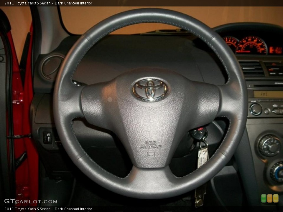 Dark Charcoal Interior Steering Wheel for the 2011 Toyota Yaris S Sedan #48767750