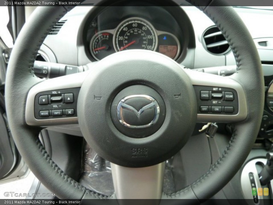 Black Interior Steering Wheel for the 2011 Mazda MAZDA2 Touring #52014339
