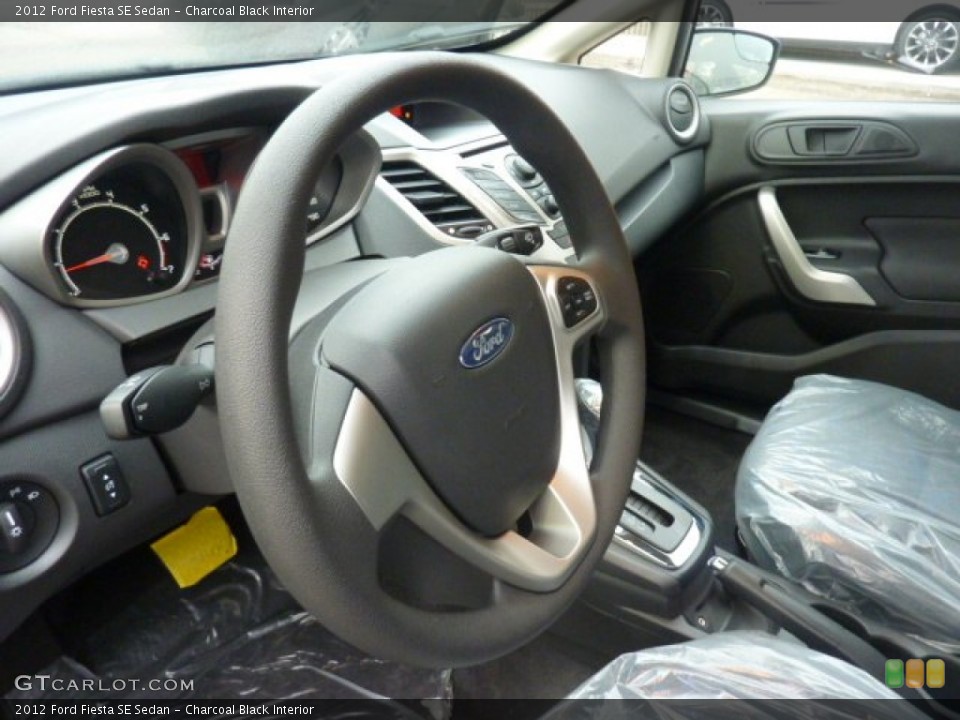 Charcoal Black Interior Steering Wheel for the 2012 Ford Fiesta SE Sedan #54081366
