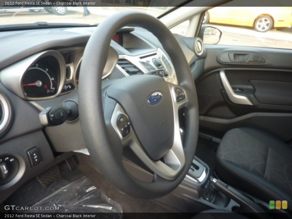 Charcoal Black Interior Steering Wheel for the 2012 Ford Fiesta SE Sedan #55128717