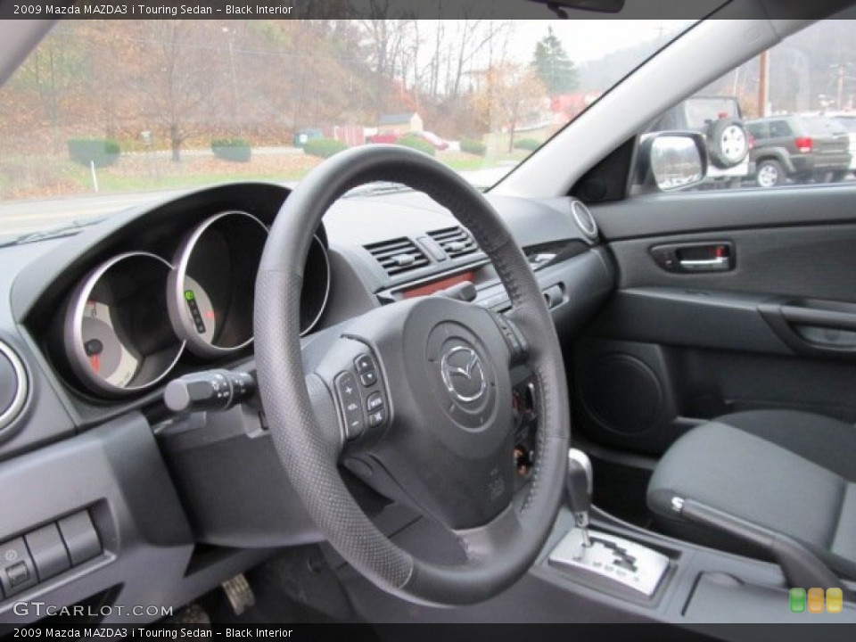 Black Interior Steering Wheel for the 2009 Mazda MAZDA3 i Touring Sedan #56793909