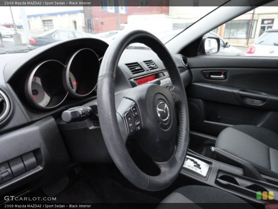 Black Interior Steering Wheel for the 2009 Mazda MAZDA3 i Sport Sedan #56842649