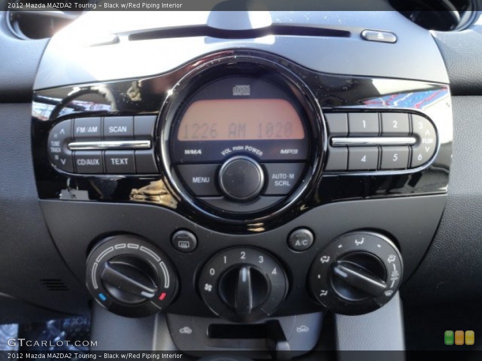 Black w/Red Piping Interior Controls for the 2012 Mazda MAZDA2 Touring #60984397