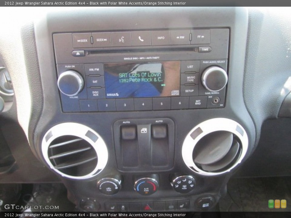 Black with Polar White Accents/Orange Stitching Interior Controls for the 2012 Jeep Wrangler Sahara Arctic Edition 4x4 #68752794