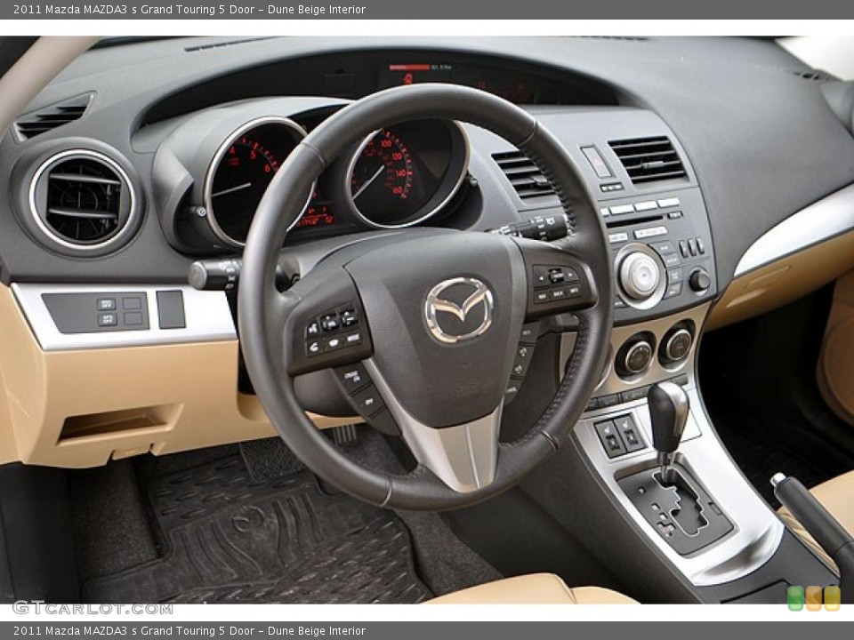 Dune Beige Interior Dashboard for the 2011 Mazda MAZDA3 s Grand Touring 5 Door #71689811