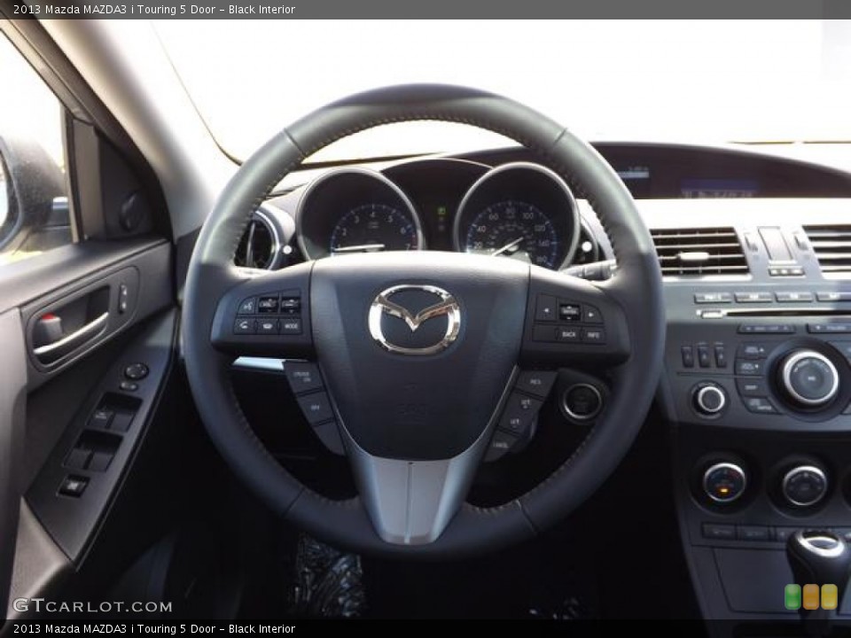 Black Interior Steering Wheel for the 2013 Mazda MAZDA3 i Touring 5 Door #78994312