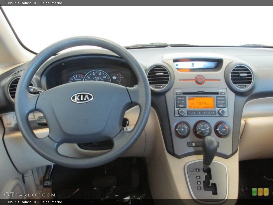 Beige Interior Dashboard for the 2009 Kia Rondo LX #81563505