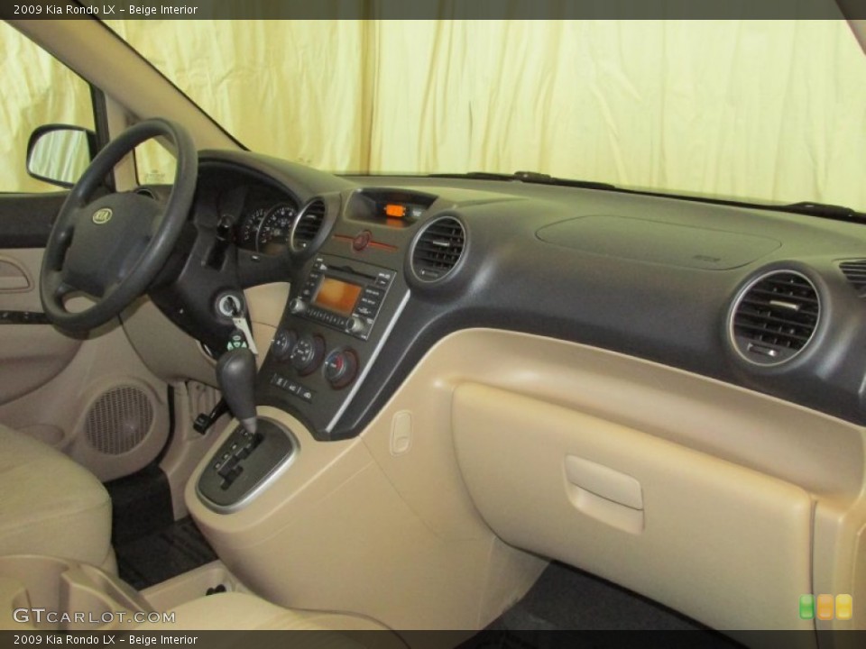 Beige Interior Dashboard for the 2009 Kia Rondo LX #81563727