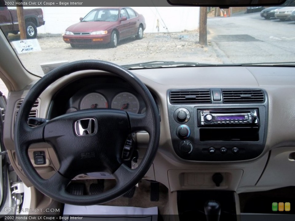 Beige Interior Dashboard for the 2002 Honda Civic LX Coupe #82314956
