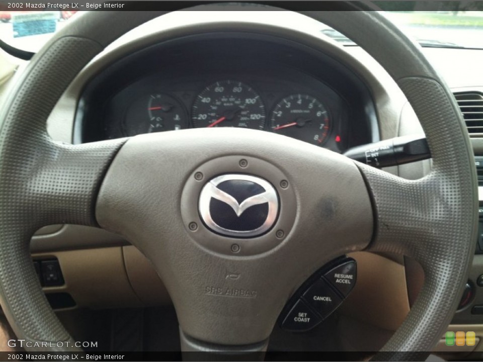 Beige Interior Steering Wheel for the 2002 Mazda Protege LX #83337518