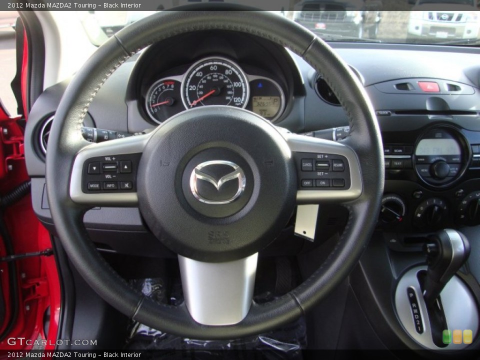Black Interior Steering Wheel for the 2012 Mazda MAZDA2 Touring #89277918