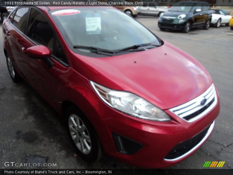 Red Candy Metallic / Light Stone/Charcoal Black Cloth 2011 Ford Fiesta SE Sedan