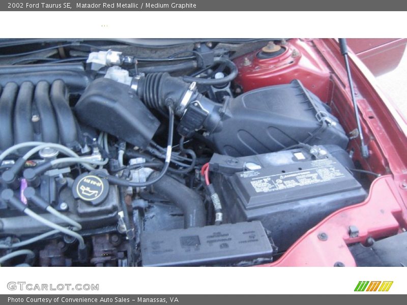 Matador Red Metallic / Medium Graphite 2002 Ford Taurus SE
