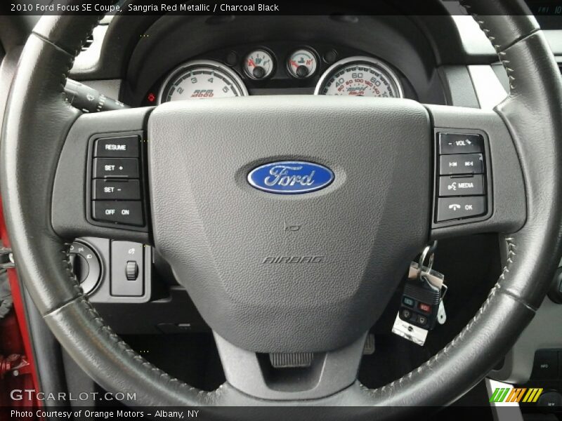 Sangria Red Metallic / Charcoal Black 2010 Ford Focus SE Coupe