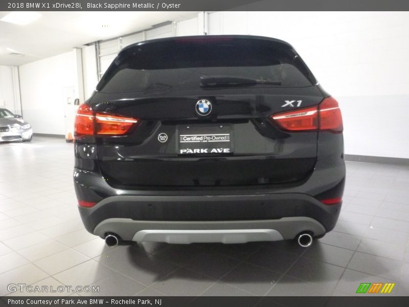 Black Sapphire Metallic / Oyster 2018 BMW X1 xDrive28i
