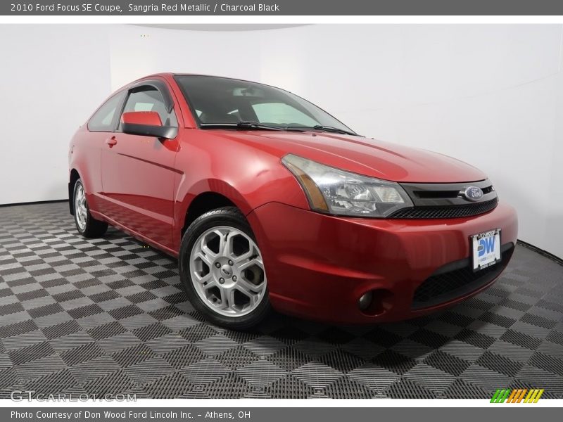 Sangria Red Metallic / Charcoal Black 2010 Ford Focus SE Coupe