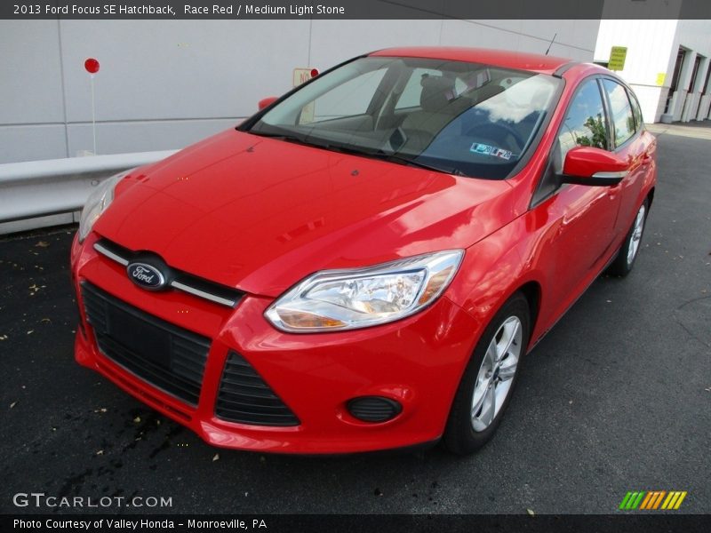 Race Red / Medium Light Stone 2013 Ford Focus SE Hatchback