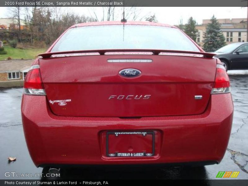 Sangria Red Metallic / Charcoal Black 2010 Ford Focus SE Coupe