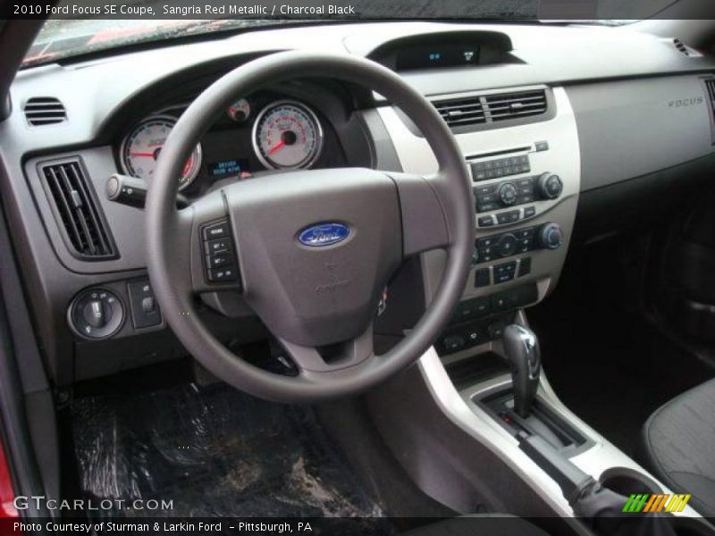 Sangria Red Metallic / Charcoal Black 2010 Ford Focus SE Coupe