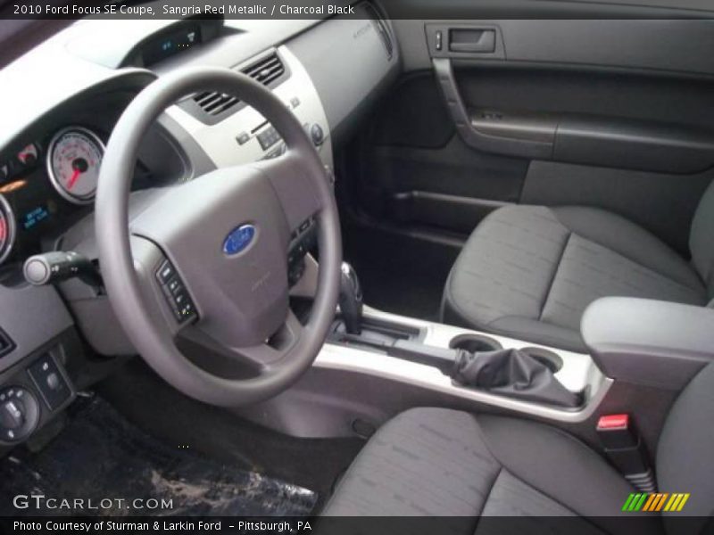 Sangria Red Metallic / Charcoal Black 2010 Ford Focus SE Coupe