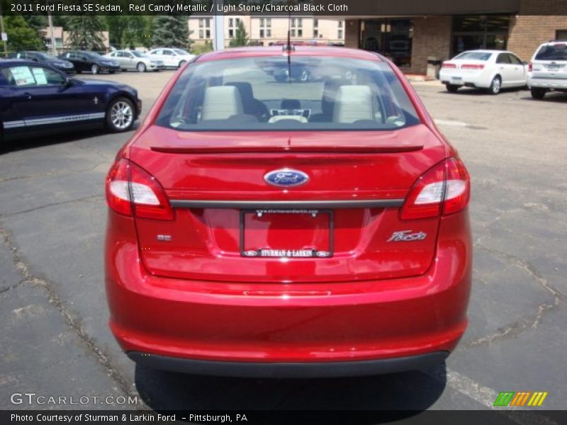 Red Candy Metallic / Light Stone/Charcoal Black Cloth 2011 Ford Fiesta SE Sedan