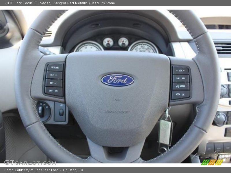Sangria Red Metallic / Medium Stone 2010 Ford Focus SEL Sedan