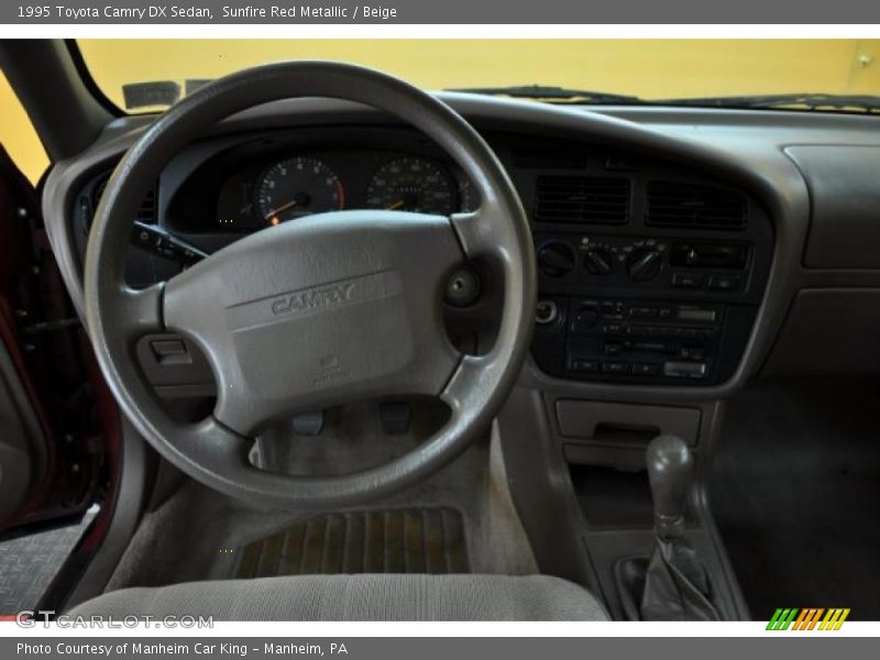 Sunfire Red Metallic / Beige 1995 Toyota Camry DX Sedan