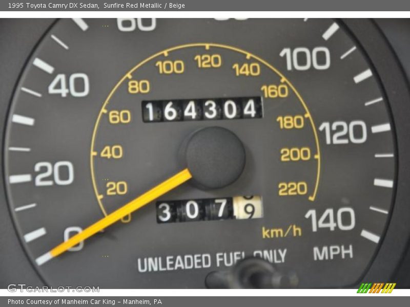 Sunfire Red Metallic / Beige 1995 Toyota Camry DX Sedan