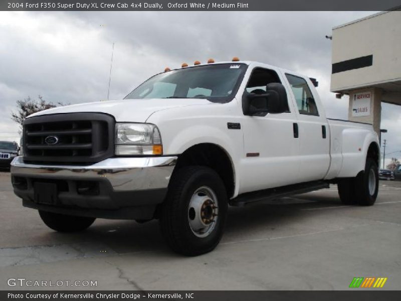 Front 3/4 View of 2004 F350 Super Duty XL Crew Cab 4x4 Dually