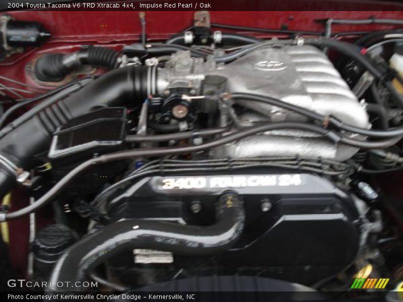 Impulse Red Pearl / Oak 2004 Toyota Tacoma V6 TRD Xtracab 4x4