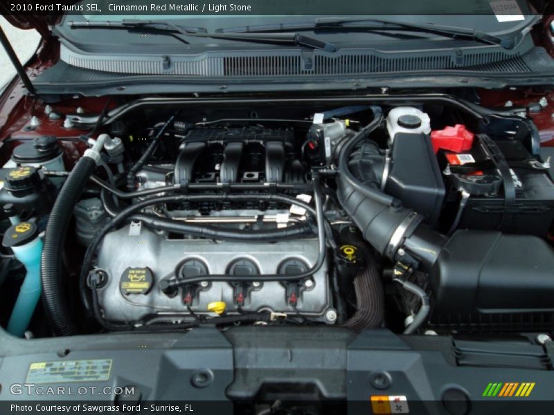 Cinnamon Red Metallic / Light Stone 2010 Ford Taurus SEL