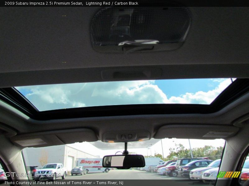 Lightning Red / Carbon Black 2009 Subaru Impreza 2.5i Premium Sedan
