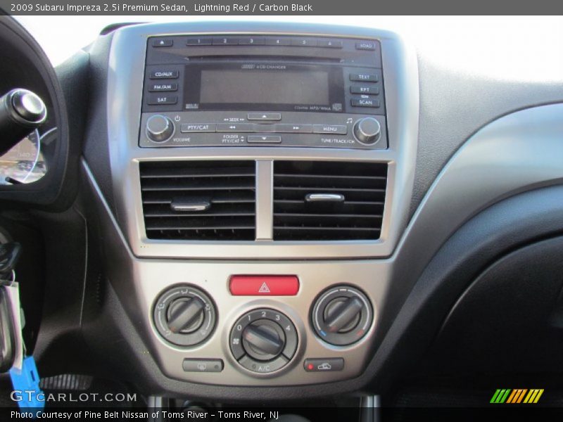Lightning Red / Carbon Black 2009 Subaru Impreza 2.5i Premium Sedan