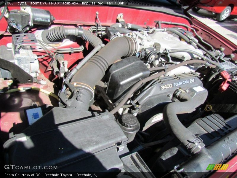 Impulse Red Pearl / Oak 2003 Toyota Tacoma V6 TRD Xtracab 4x4