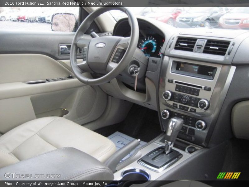 Sangria Red Metallic / Medium Light Stone 2010 Ford Fusion SEL