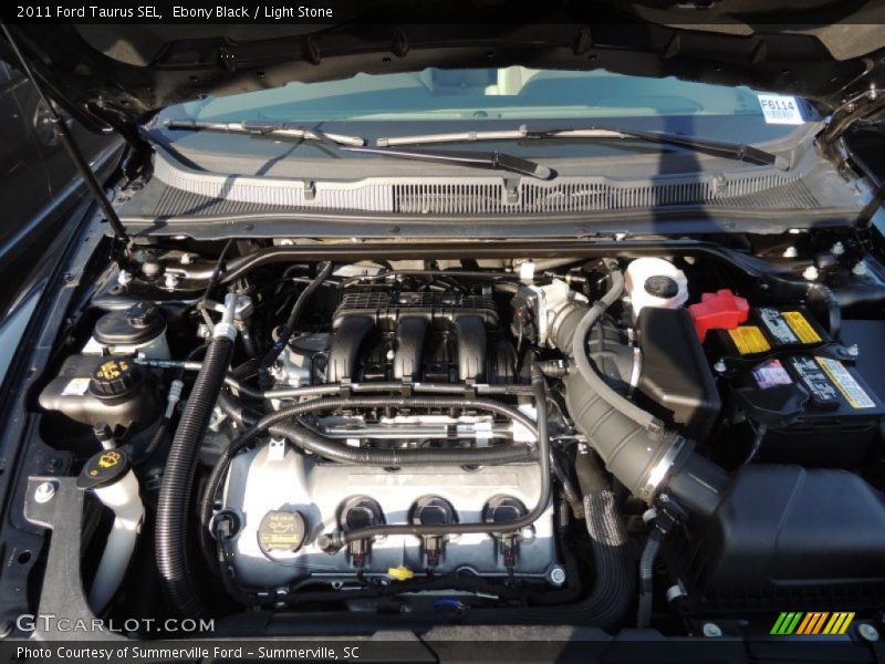 Ebony Black / Light Stone 2011 Ford Taurus SEL