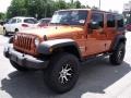 2010 Mango Tango Pearl Jeep Wrangler Unlimited Sport 4x4  photo #4