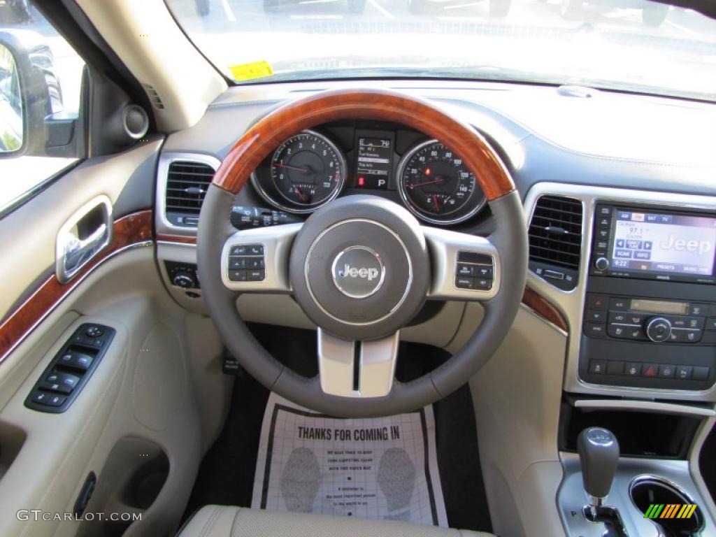 2011 Jeep Grand Cherokee Overland Dark Frost Beige/Light Frost Beige Steering Wheel Photo #38315926